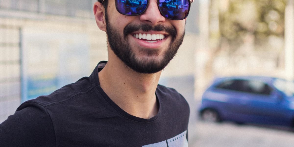 A confident person smiling, reflecting successful decision-making in investments.