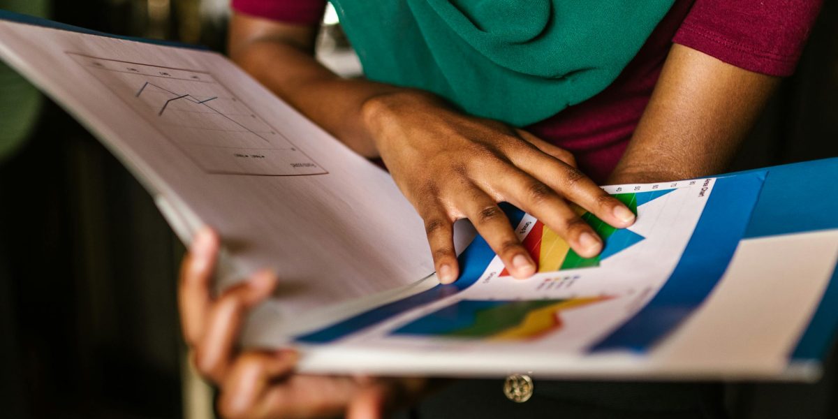 A confident person reviewing financial charts, symbolizing smart investment decisions.