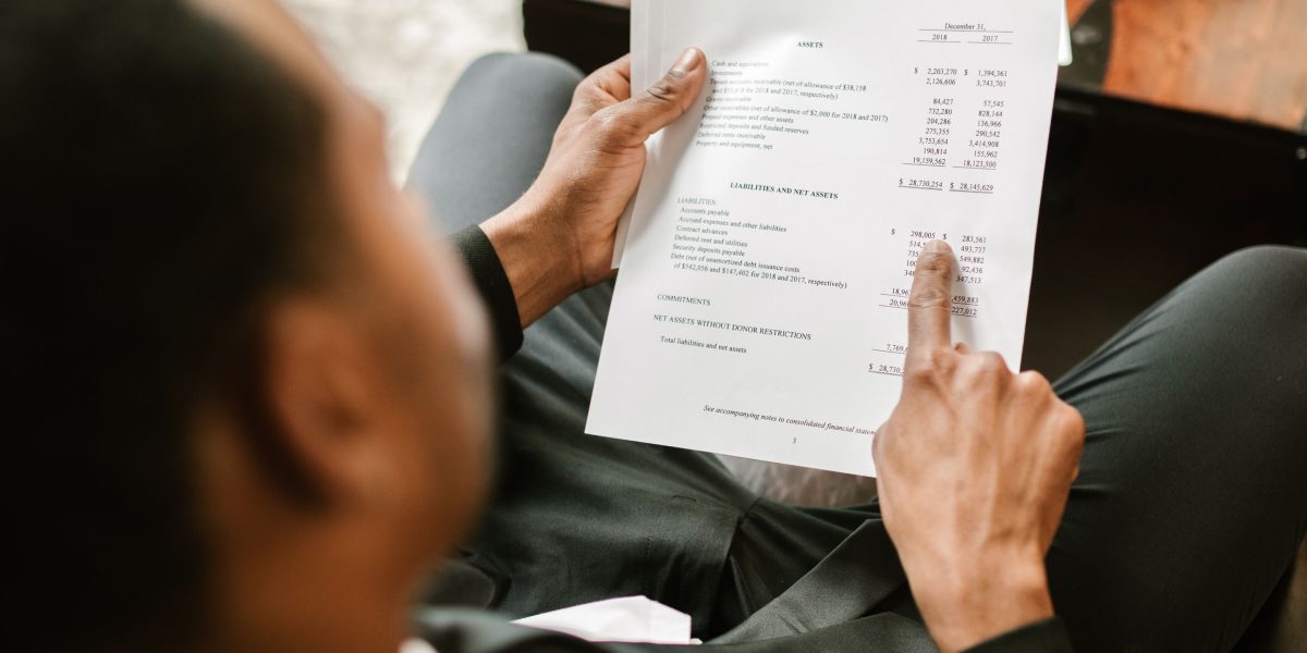 An investor confidently reviewing documents, symbolizing readiness to make a strategic move.