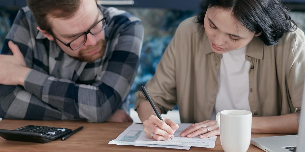A couple carefully reviewing financial plans and budgeting for property investment in Dubai.